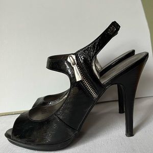 Patent strap oy heel with zipper.